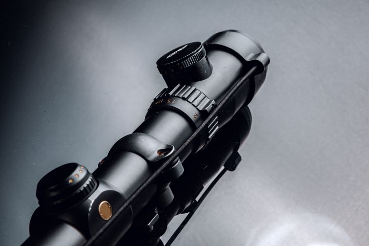 Black rifle optical sight on black background